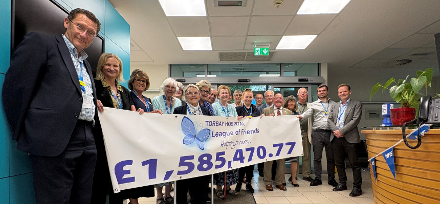A group of people holding a banner with £1.58million written on it