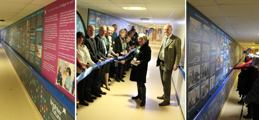 Image: Liz Davenport, Chief Executive, and Sir Richard Ibbotson, Chairman, cut the ribbon on the new graphic timeline on a Torbay Hospital corridor