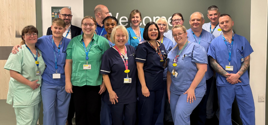 Members of the endoscopy team standing in front of a welcome sign
