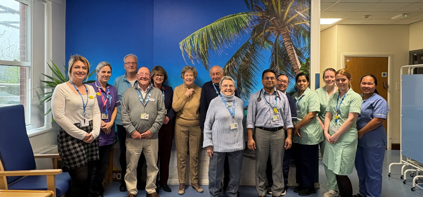 Members of Torbay Hospital's League of Friends, with staff from Cheetham Hill, and George Earle wards standing in front of one of the vinyl wall art