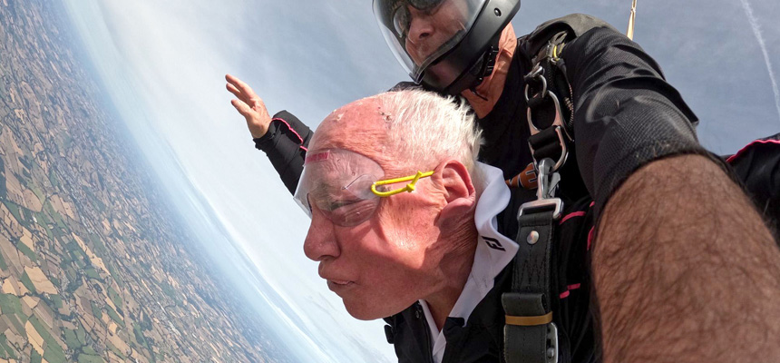 John Payne with his skydiving instructor as free fall above Devon.