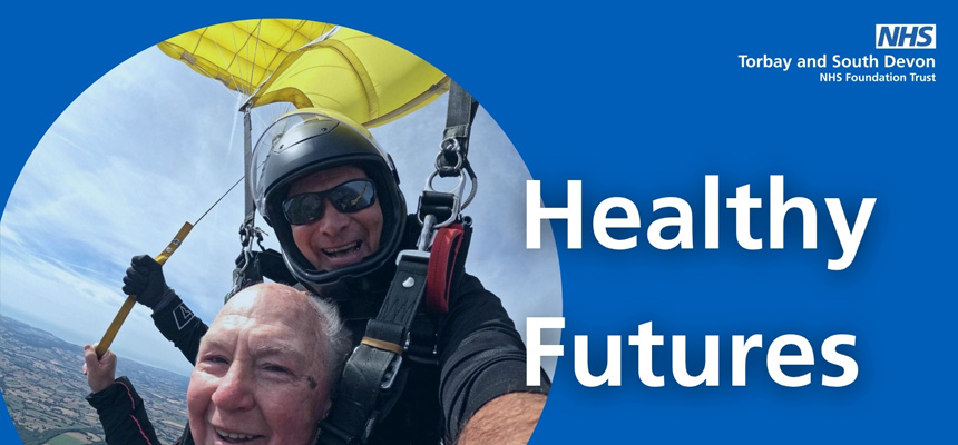 Healthy Futures magazine cover banner. Featuring John Payne with his skydiving instructor as they glide back down.
