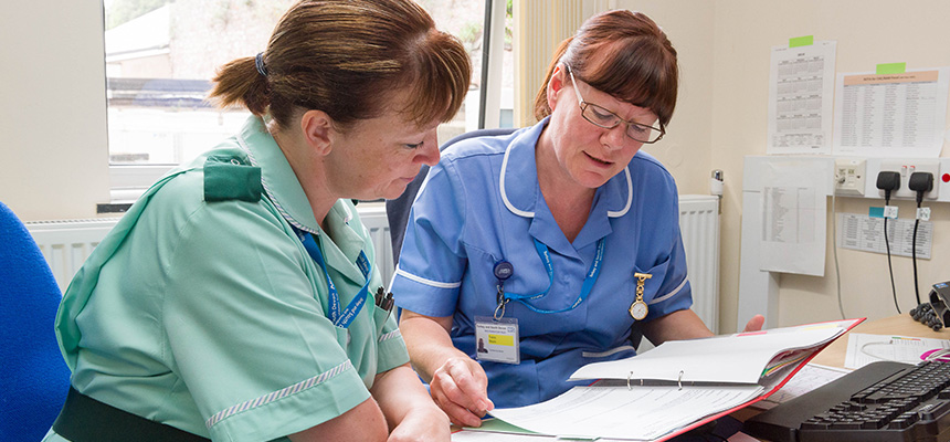 Nurses discussing notes
